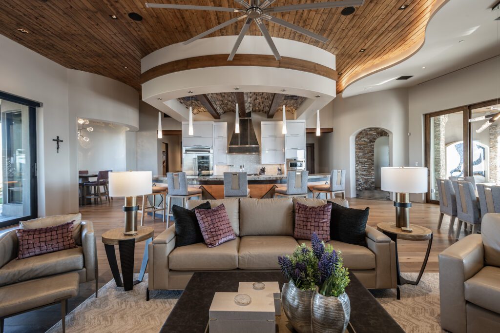 Photo of a luxurious celebrity custom home family room with curved walls and beautiful views of the Scottsdale mountains